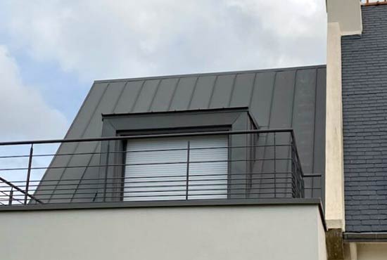Photo d'une couverture en zinc avec fenêtre donnant sur toiture-terrasse